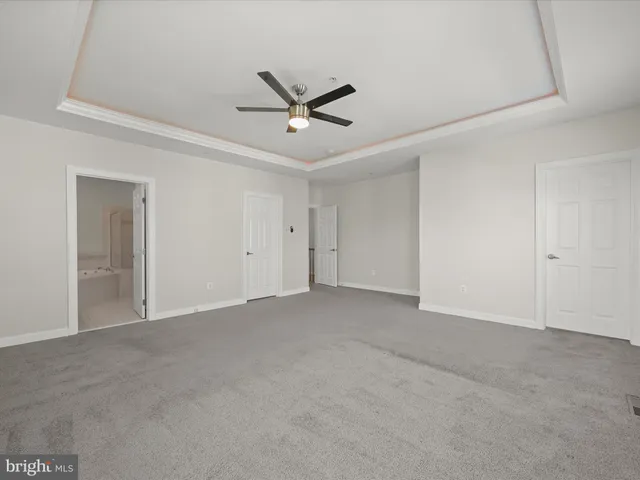 a bathroom with a bathtub a mirror a double vanity sink and vanity