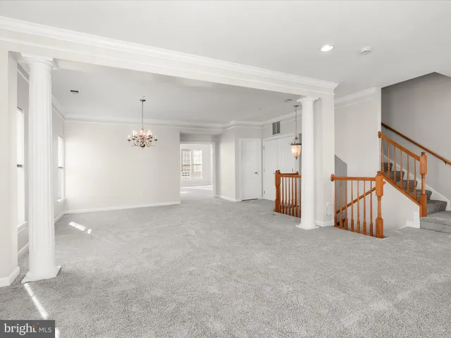 a view of a livingroom with furniture and staircase