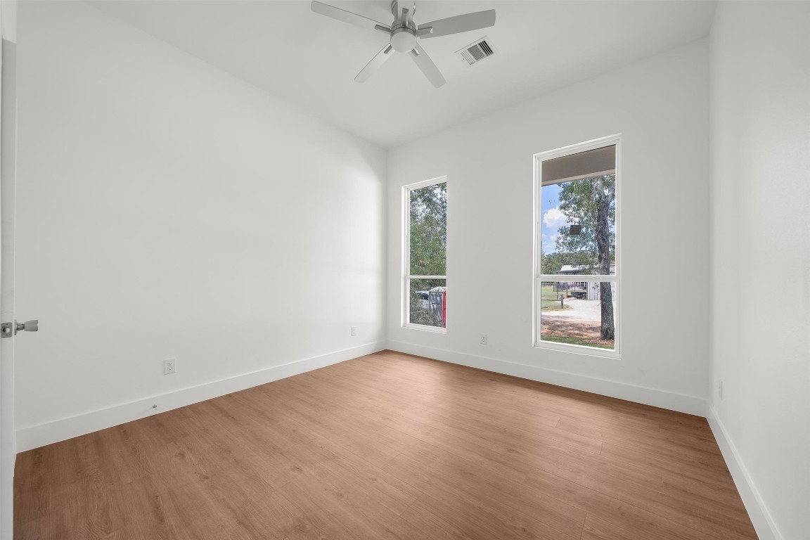 24651 Sligo Street Hempstead, TX 77445 - Photo 23 of 38 an empty room with windows and ceiling fan