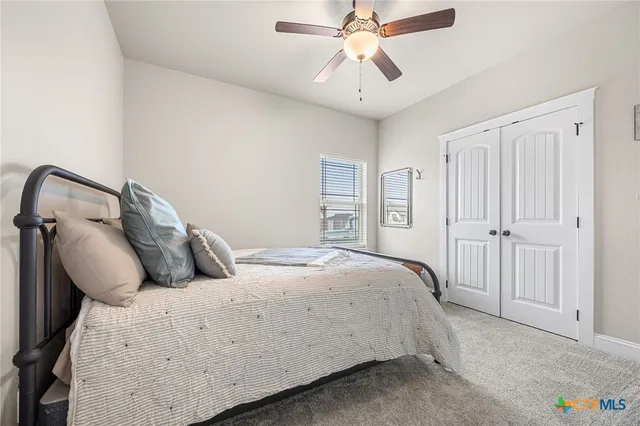 a spacious bathroom with a double vanity sink a large mirror and shower