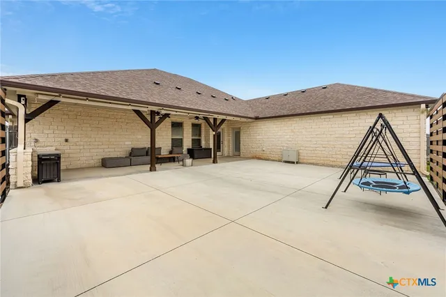 a view of a backyard with wooden fence