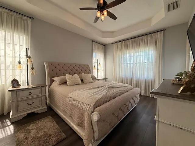 a view of bedroom with wooden floor and window