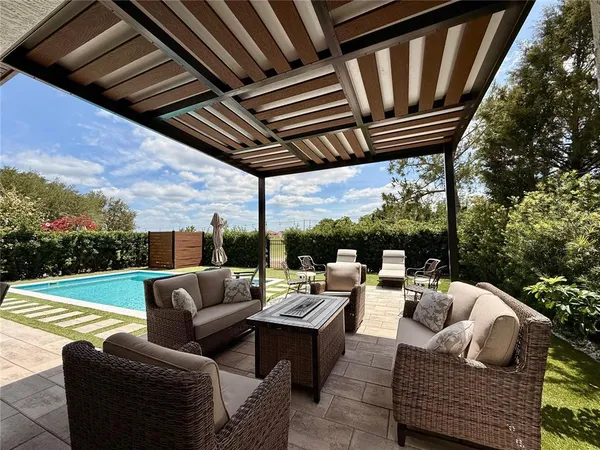 a view of a backyard with sitting area