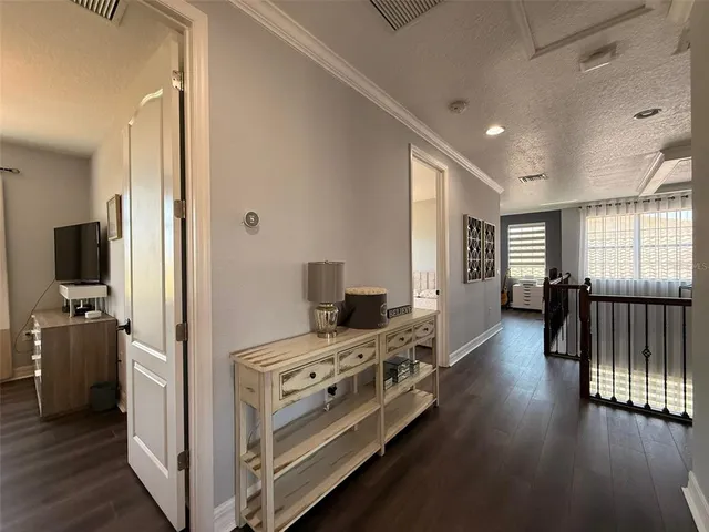 a en suite bathroom with a granite countertop sink a toilet and a mirror