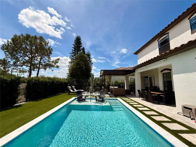 a view of a patio with swimming pool table and chairs
