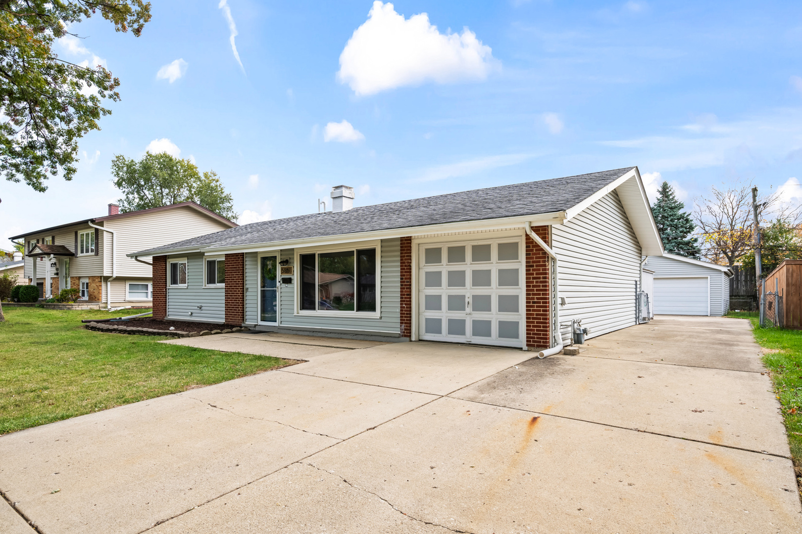 a view of house with yard and sitting area