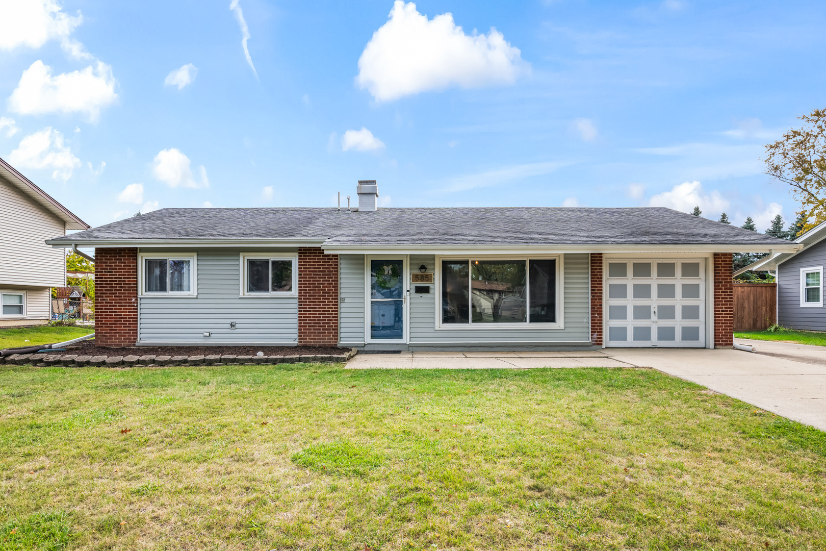 585 Amherst Lane Hoffman Estates, IL 60169 - Photo 2 of 25 a front view of a house with a yard and garage