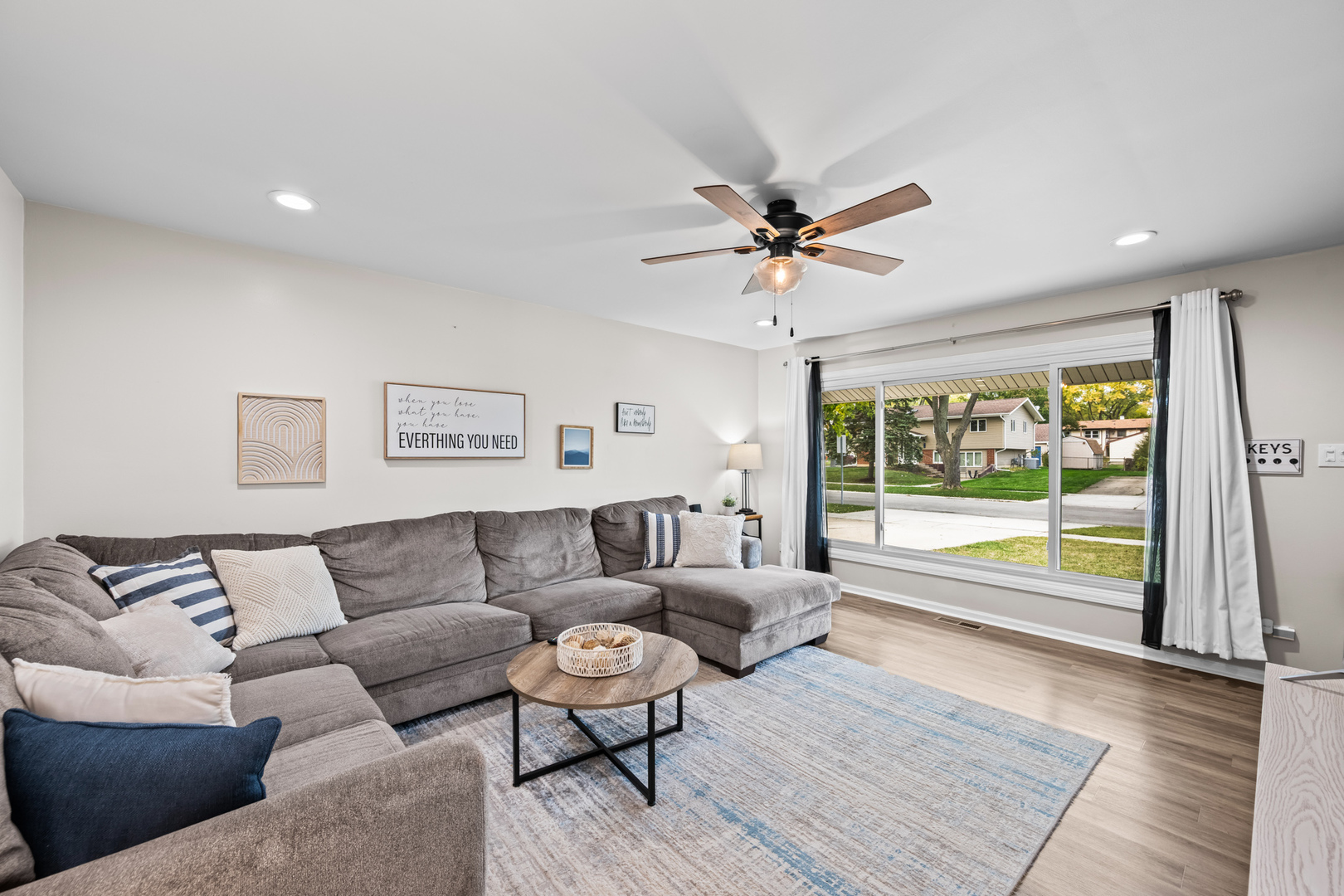 585 Amherst Lane Hoffman Estates, IL 60169 - Photo 6 of 25 a living room with furniture and a large window