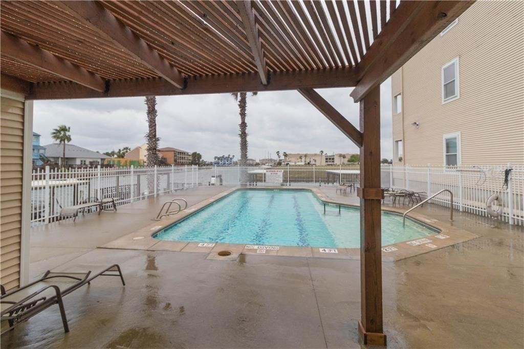 14427 Compass Street, Unit B10 Corpus Christi, TX 78418 - Photo 14 of 16 a view of a swimming pool with a patio