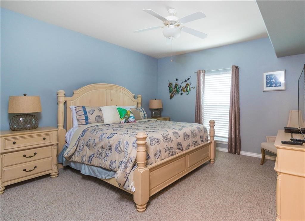 14427 Compass Street, Unit B10 Corpus Christi, TX 78418 - Photo 3 of 16 a bedroom with a bed and a dresser