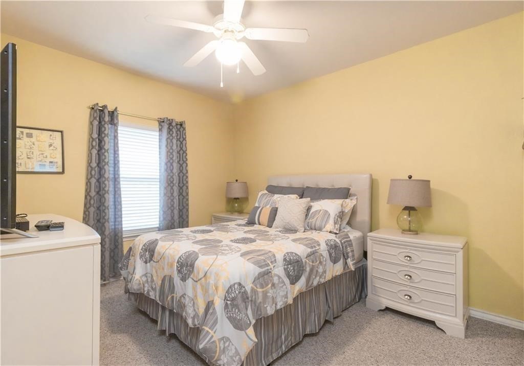 14427 Compass Street, Unit B10 Corpus Christi, TX 78418 - Photo 7 of 16 a bedroom with a bed and a chandelier