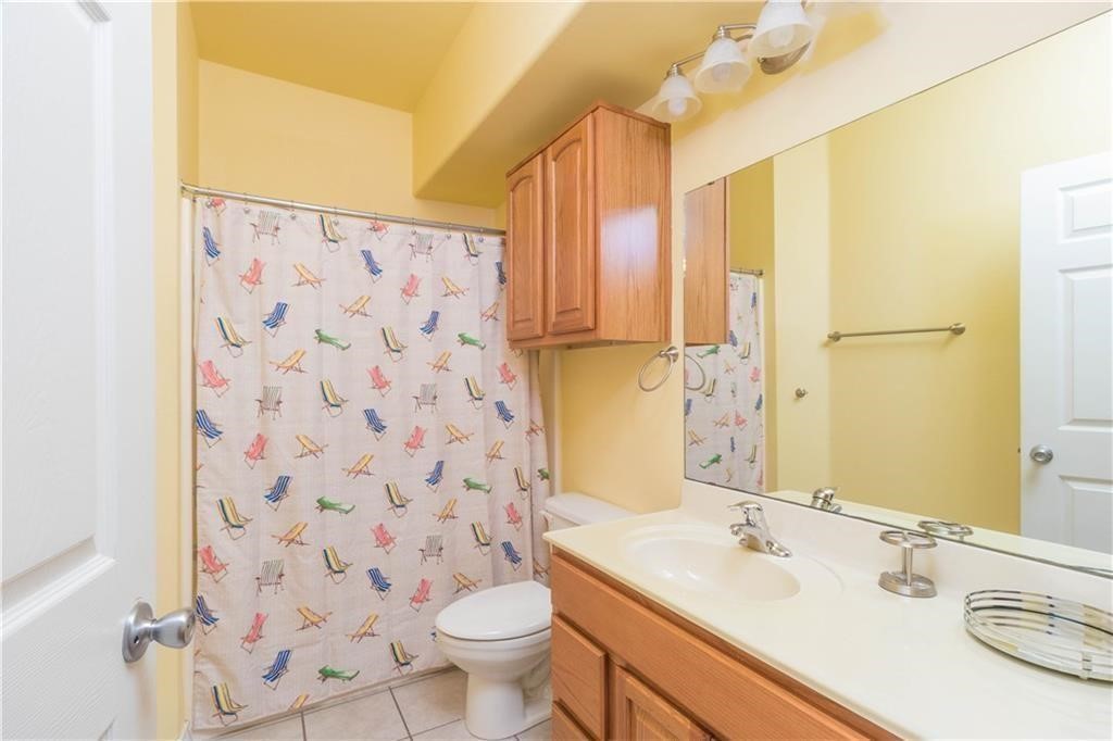 14427 Compass Street, Unit B10 Corpus Christi, TX 78418 - Photo 8 of 16 a bathroom with a sink toilet a mirror and shower