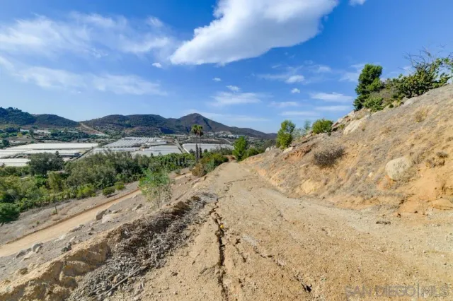 a view of a road with a house in the background