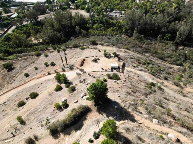 a view of a dry yard with mountains in the background