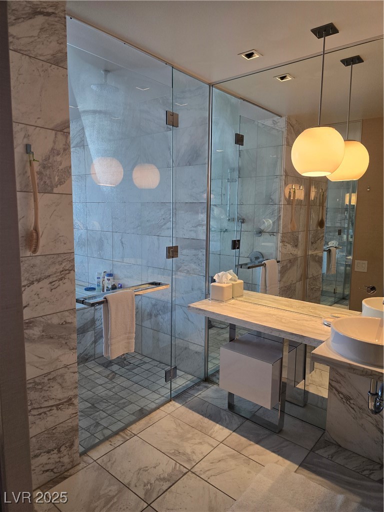 4381 West Flamingo Road, Unit 3109 Las Vegas, NV 89103 - Photo 15 of 28 Full bathroom with a shower stall, marble finish floor, and vanity