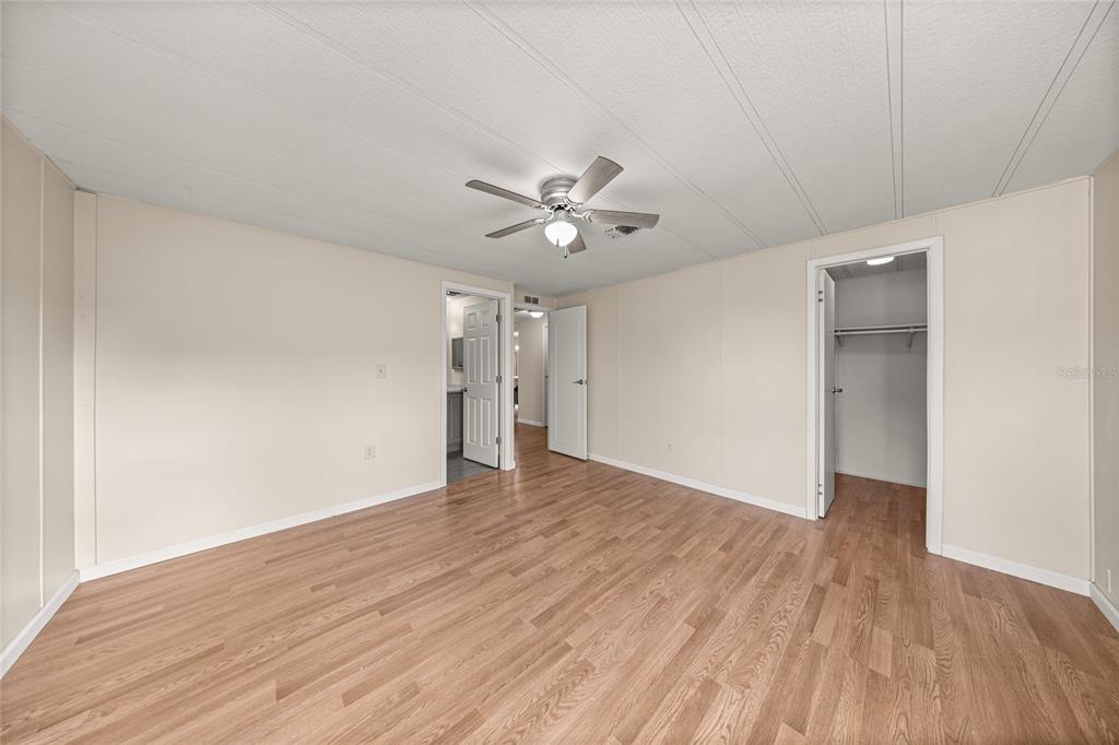 712 Devon Drive Lady Lake, FL 32159 - Photo 14 of 31 a view of an empty room with wooden floor