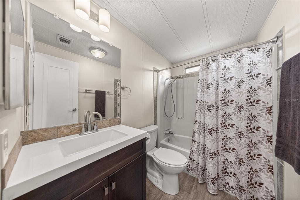 712 Devon Drive Lady Lake, FL 32159 - Photo 20 of 31 a bathroom with a sink a toilet and shower