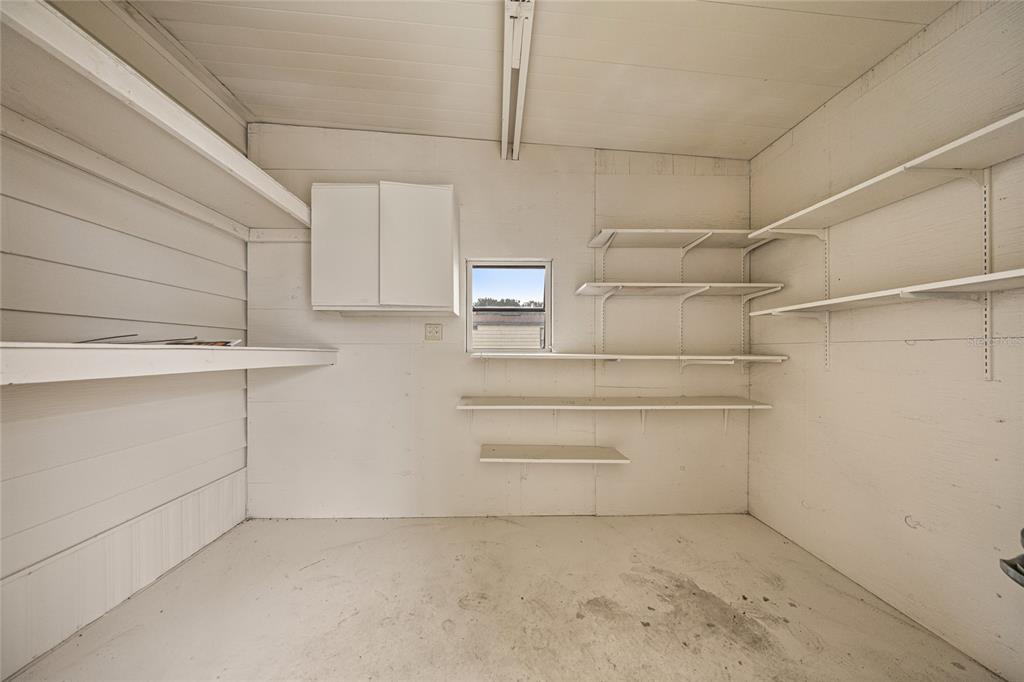 712 Devon Drive Lady Lake, FL 32159 - Photo 24 of 31 a view of walk in closet with empty racks