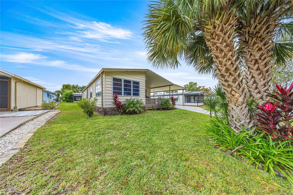 712 Devon Drive Lady Lake, FL 32159 - Photo 25 of 31 a front view of house with yard and green space