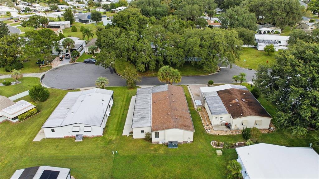 712 Devon Drive Lady Lake, FL 32159 - Photo 28 of 31 an aerial view of a house with yard swimming pool and outdoor seating