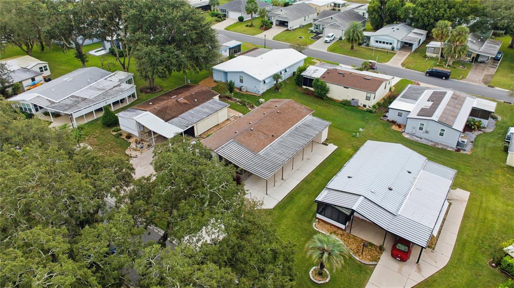 712 Devon Drive Lady Lake, FL 32159 - Photo 30 of 31 an aerial view of a house with swimming pool and outdoor space