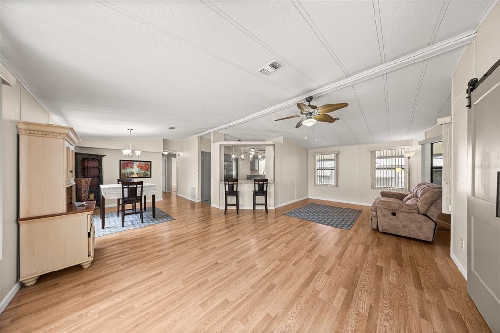712 Devon Drive Lady Lake, FL 32159 - Photo 7 of 31 a living room with furniture and a wooden floor