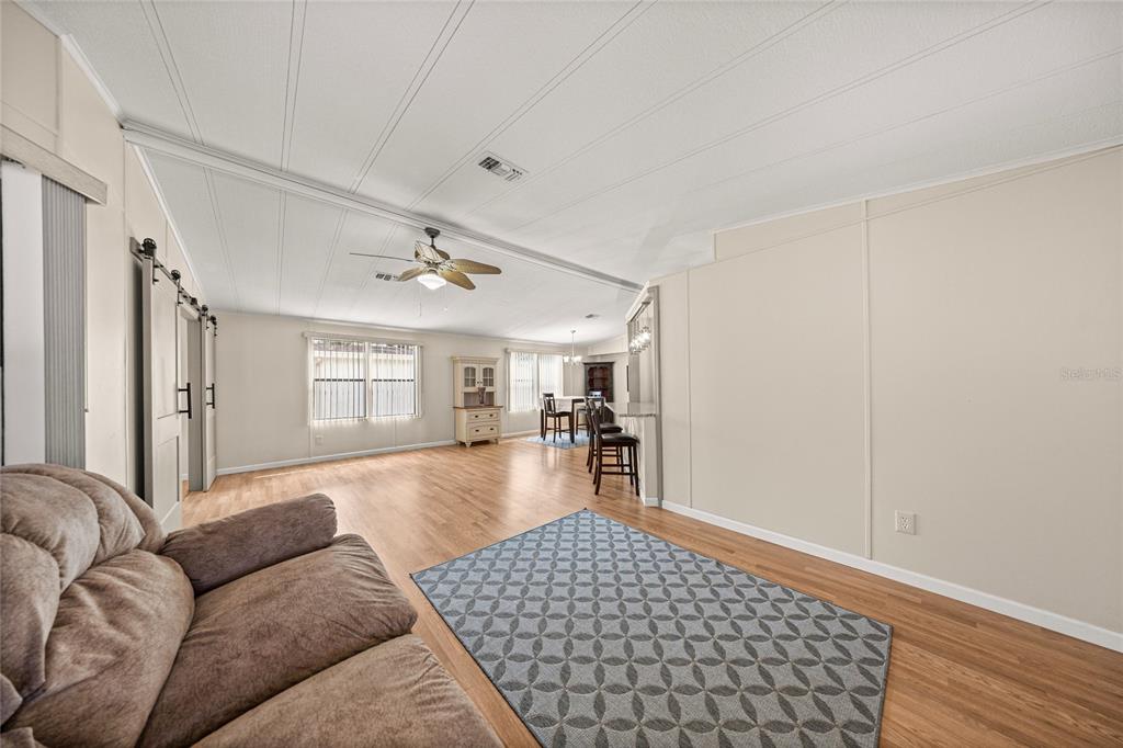 712 Devon Drive Lady Lake, FL 32159 - Photo 8 of 31 a living room with furniture and wooden floor