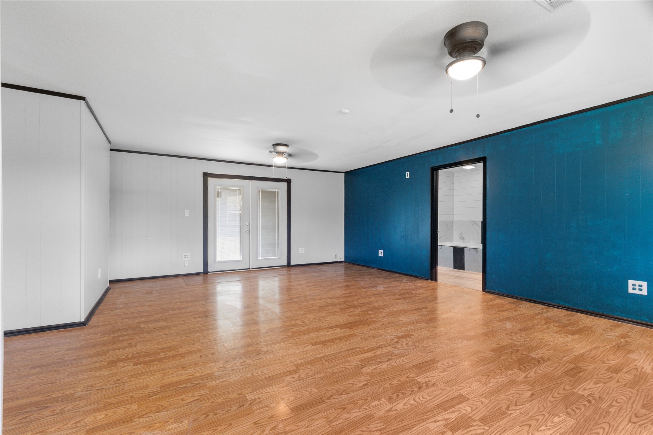 10315 North Walker Road Cleveland, TX 77328 - Photo 11 of 27 a view of an empty room with a window and a kitchen