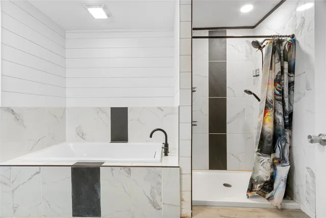 a bathroom with a bathtub and shower