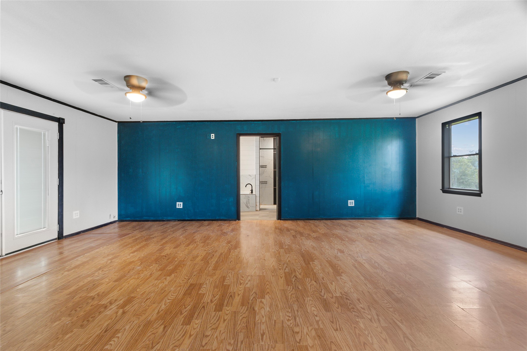 10315 North Walker Road Cleveland, TX 77328 - Photo 17 of 27 a view of an empty room with closet and wooden floor