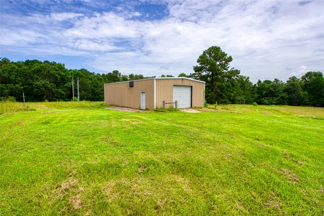 a view of a big yard with a house in the background