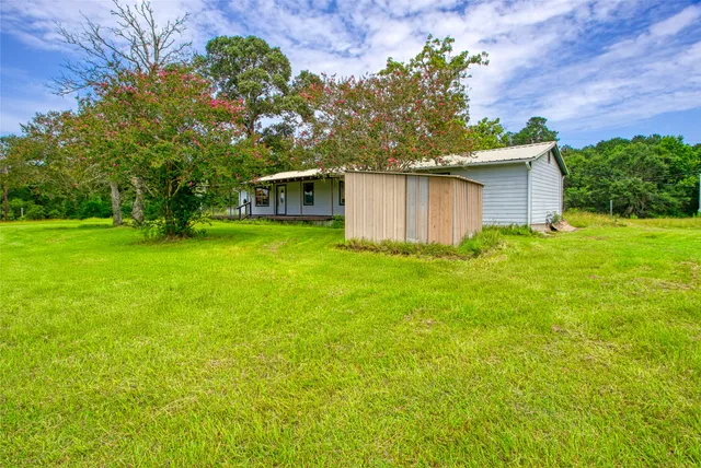 a front view of house with yard and trees