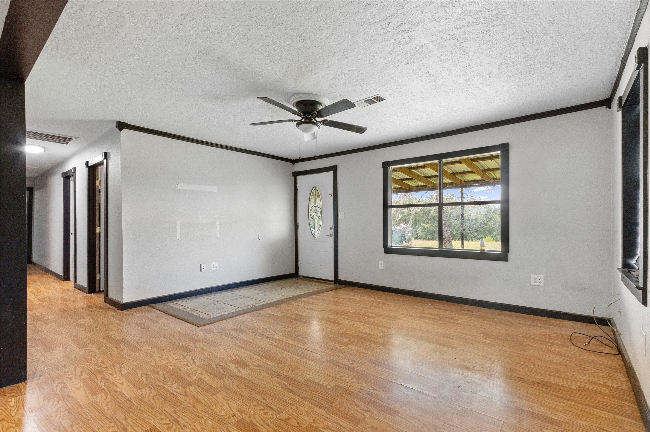 10315 North Walker Road Cleveland, TX 77328 - Photo 5 of 27 an empty room with windows and ceiling fan