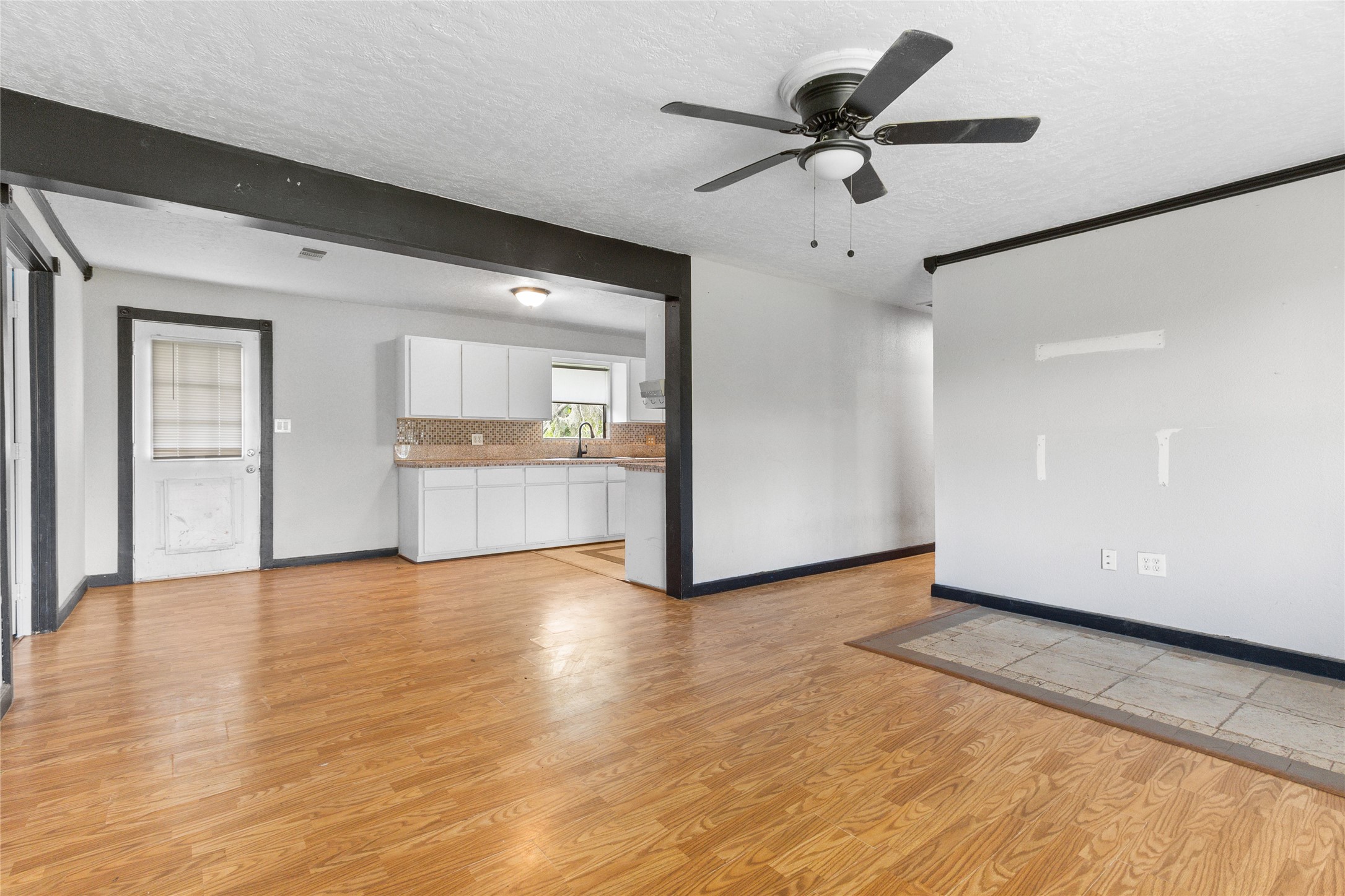 10315 North Walker Road Cleveland, TX 77328 - Photo 7 of 27 a view of an empty room with window and wooden floor