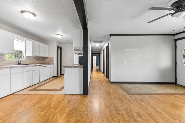 a view of a kitchen with a sink and a refrigerator