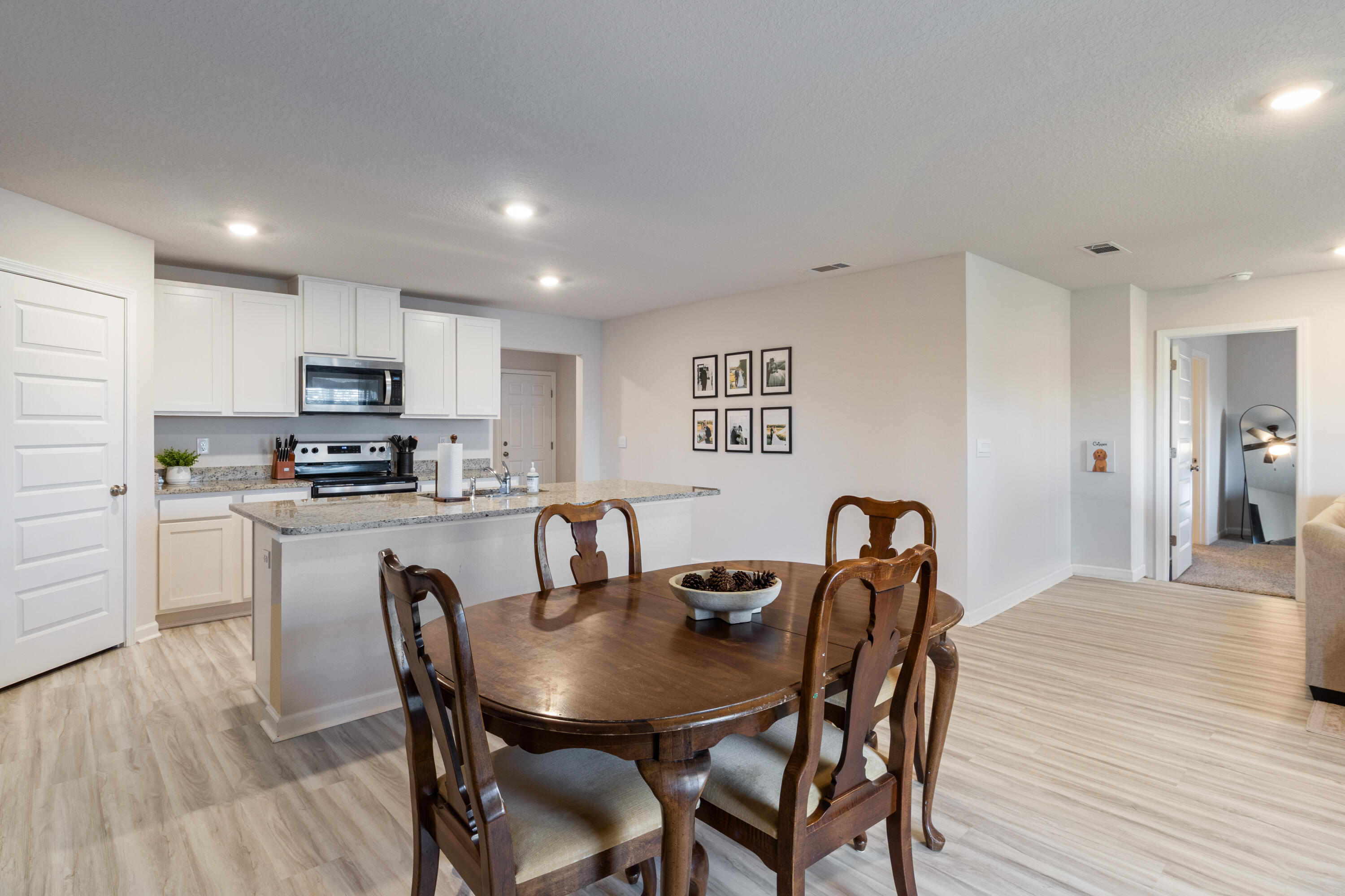 848 Otto Loop Crestview, FL 32539 - Photo 11 of 26 a kitchen with granite countertop white cabinets and stainless steel appliances