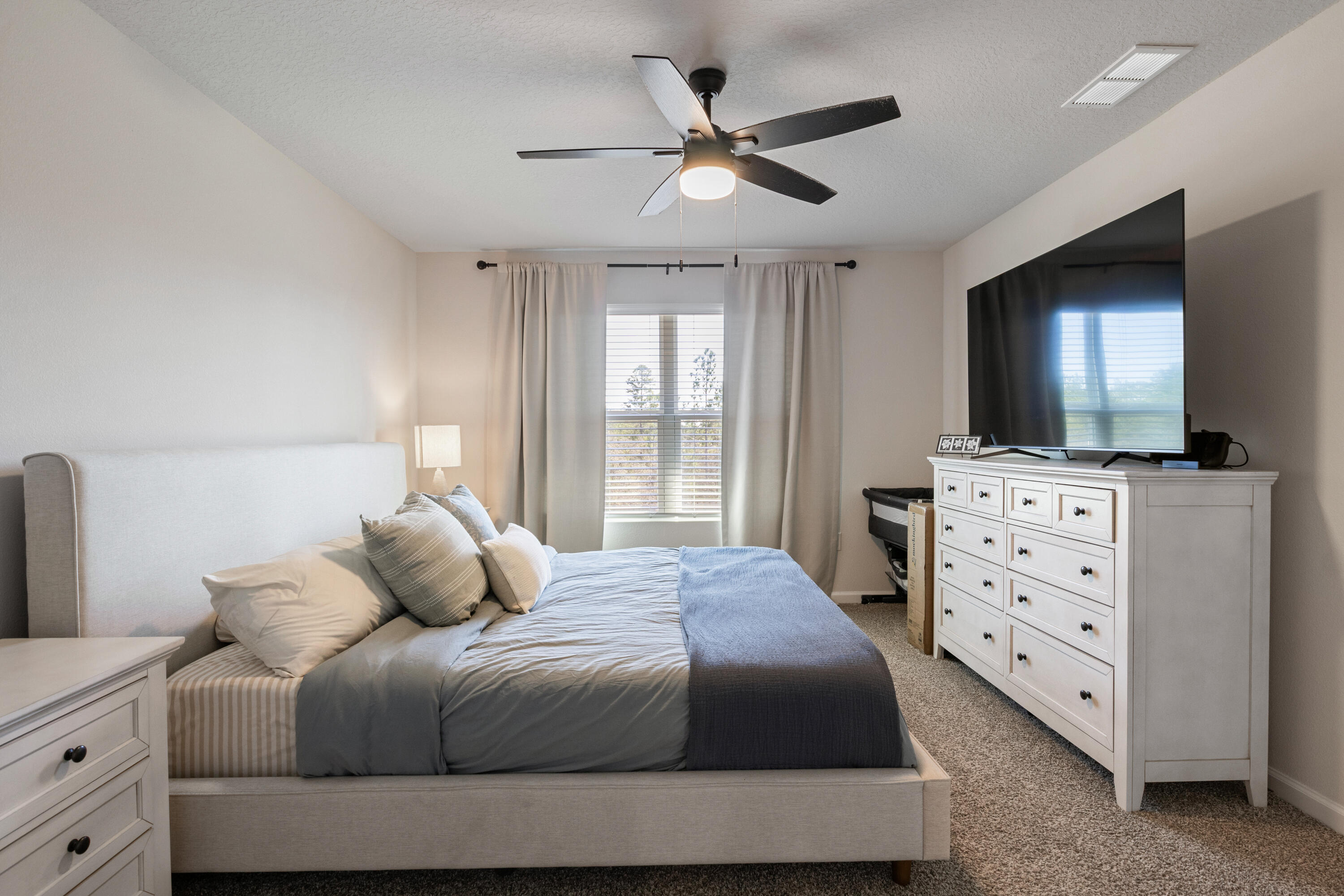 848 Otto Loop Crestview, FL 32539 - Photo 15 of 26 a bedroom with a bed and a flat screen tv