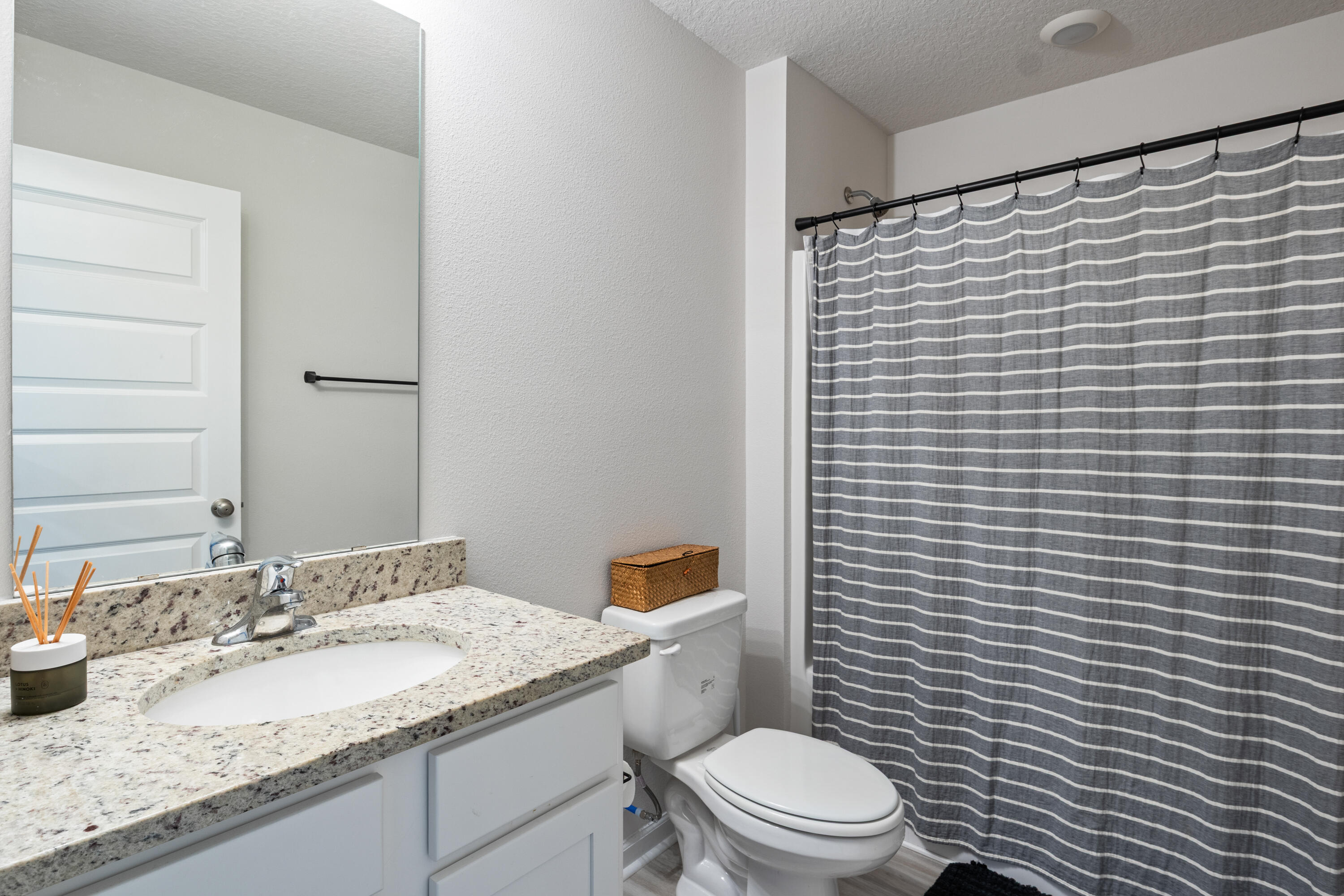 848 Otto Loop Crestview, FL 32539 - Photo 22 of 26 a bathroom with a granite countertop toilet a sink and a mirror