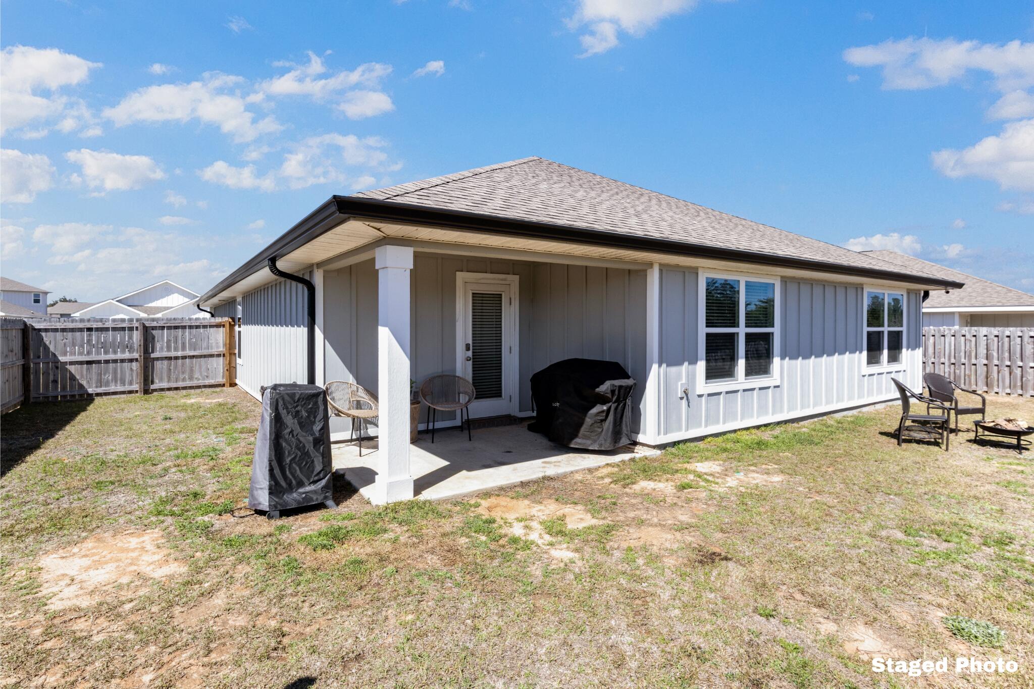 848 Otto Loop Crestview, FL 32539 - Photo 24 of 26 a view of a house with a patio and a yard