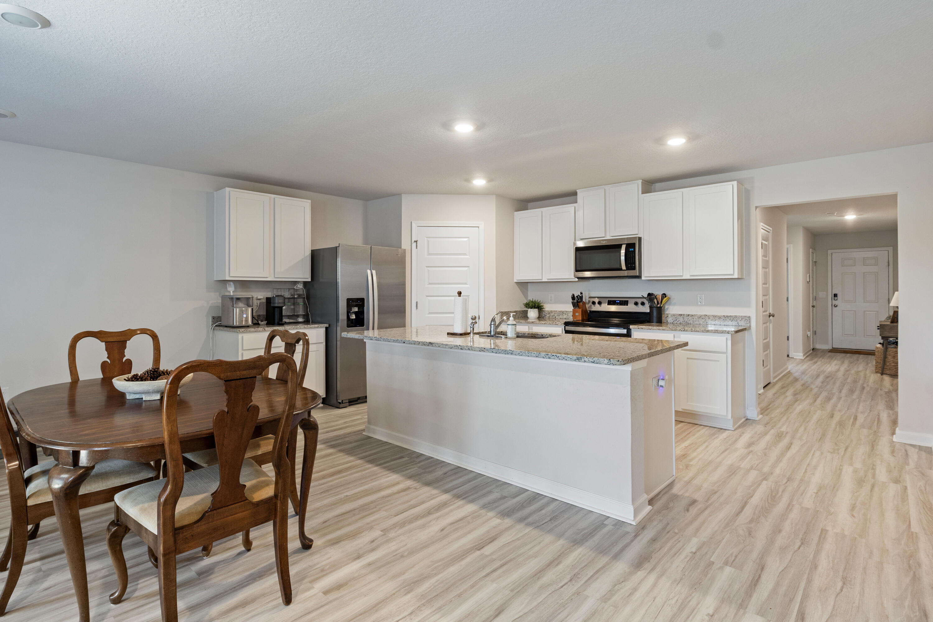 848 Otto Loop Crestview, FL 32539 - Photo 6 of 26 a kitchen with a dining table chairs and refrigerator