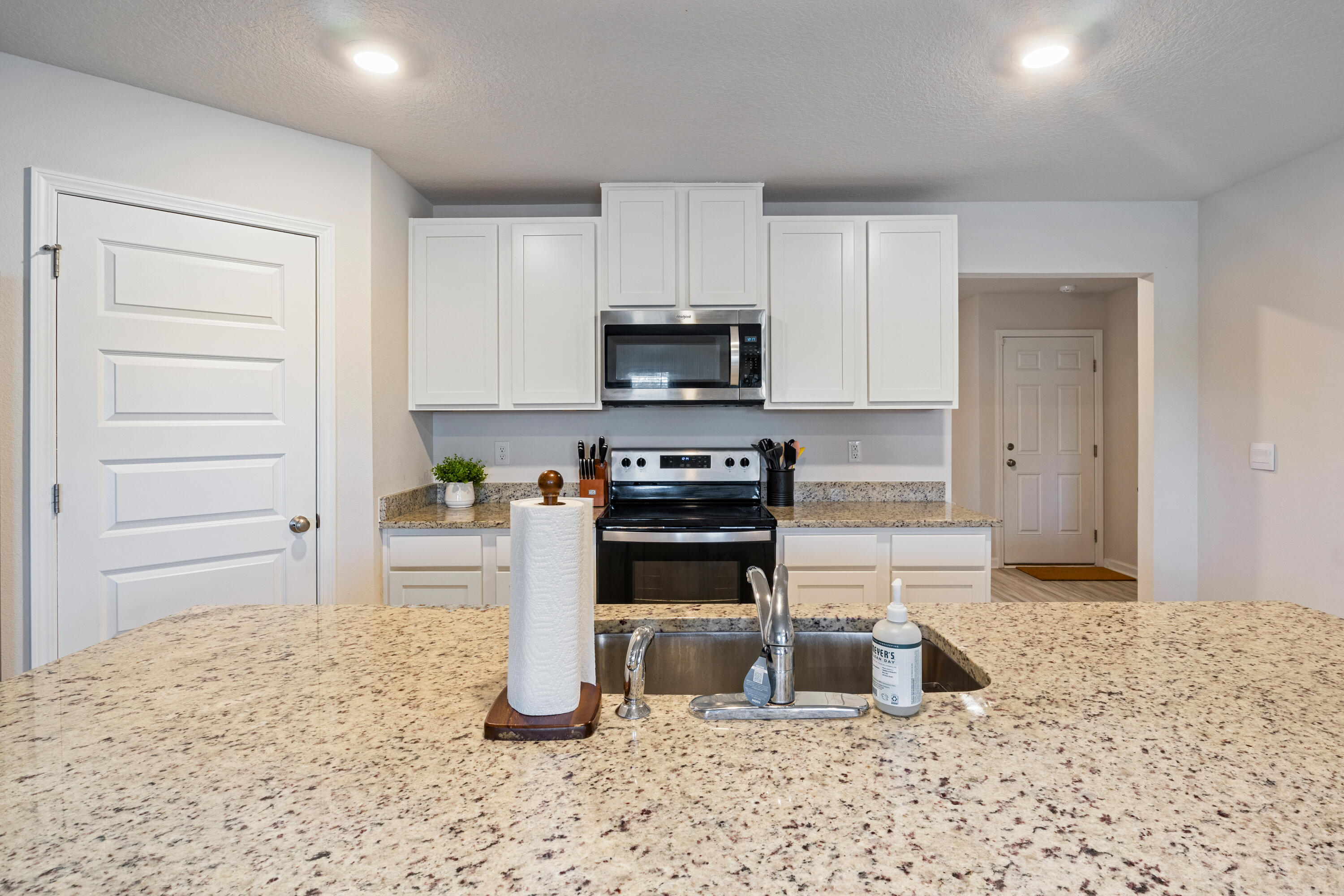 848 Otto Loop Crestview, FL 32539 - Photo 8 of 26 a kitchen with a stove a microwave and a refrigerator