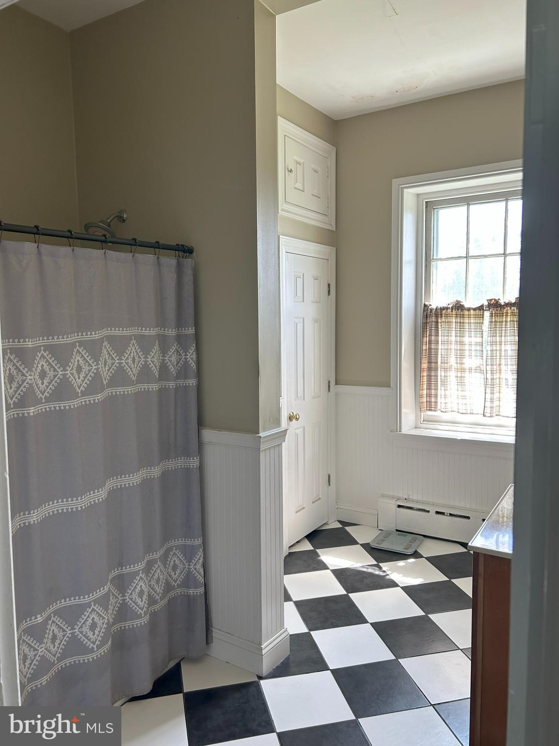 842 Salem Quinton Road Quinton, NJ 08079 - Photo 13 of 21 a room with a black white checkered floor with a gaming machine and a potted plant