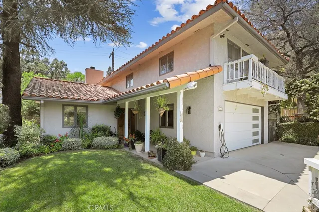 a view of a white house next to a yard
