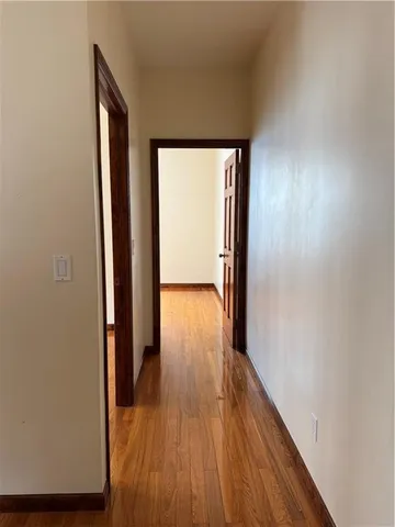a view of hallway with wooden floor