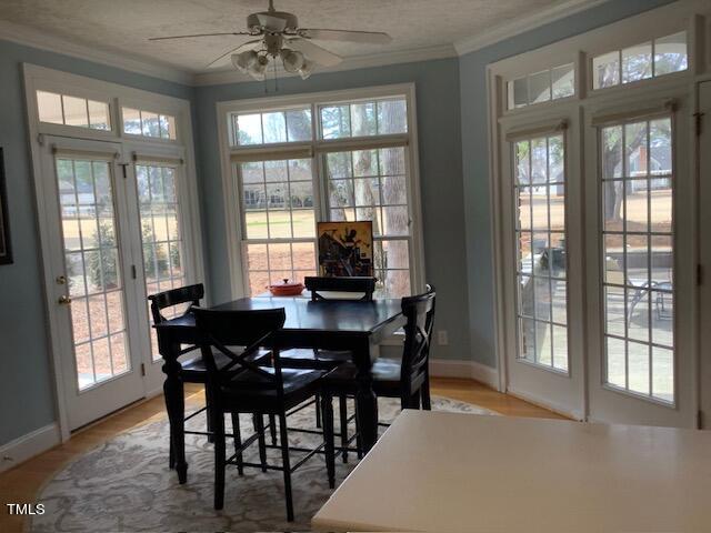 2125 Keith Hills Road Lillington, NC 27546 - Photo 15 of 66 a dining room with furniture a chandelier and wooden floor