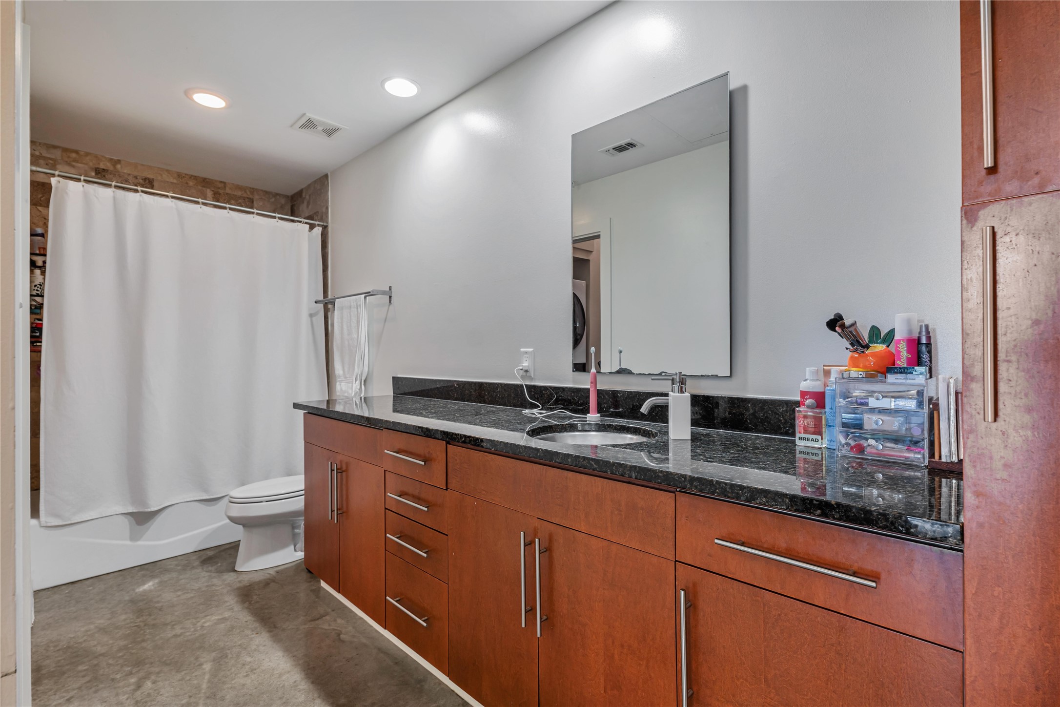 2124 East 6th Street, Unit 305 Austin, TX 78702 - Photo 18 of 35 a bathroom with double vanity and a mirror
