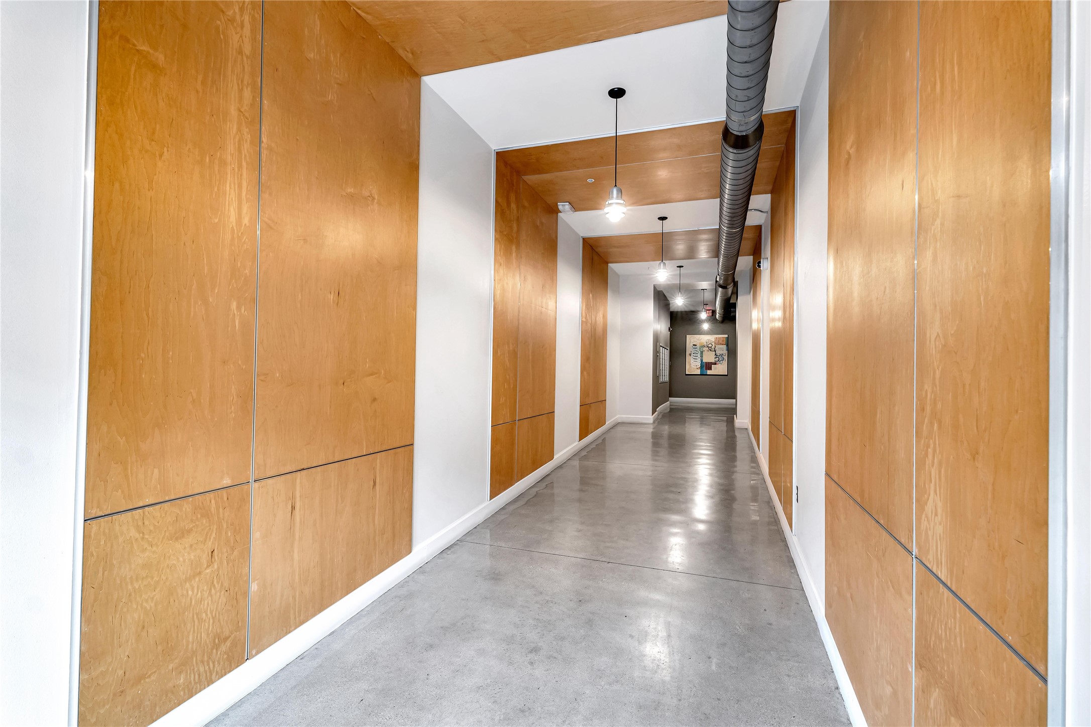 2124 East 6th Street, Unit 305 Austin, TX 78702 - Photo 4 of 35 a view of a hallway with wooden floor