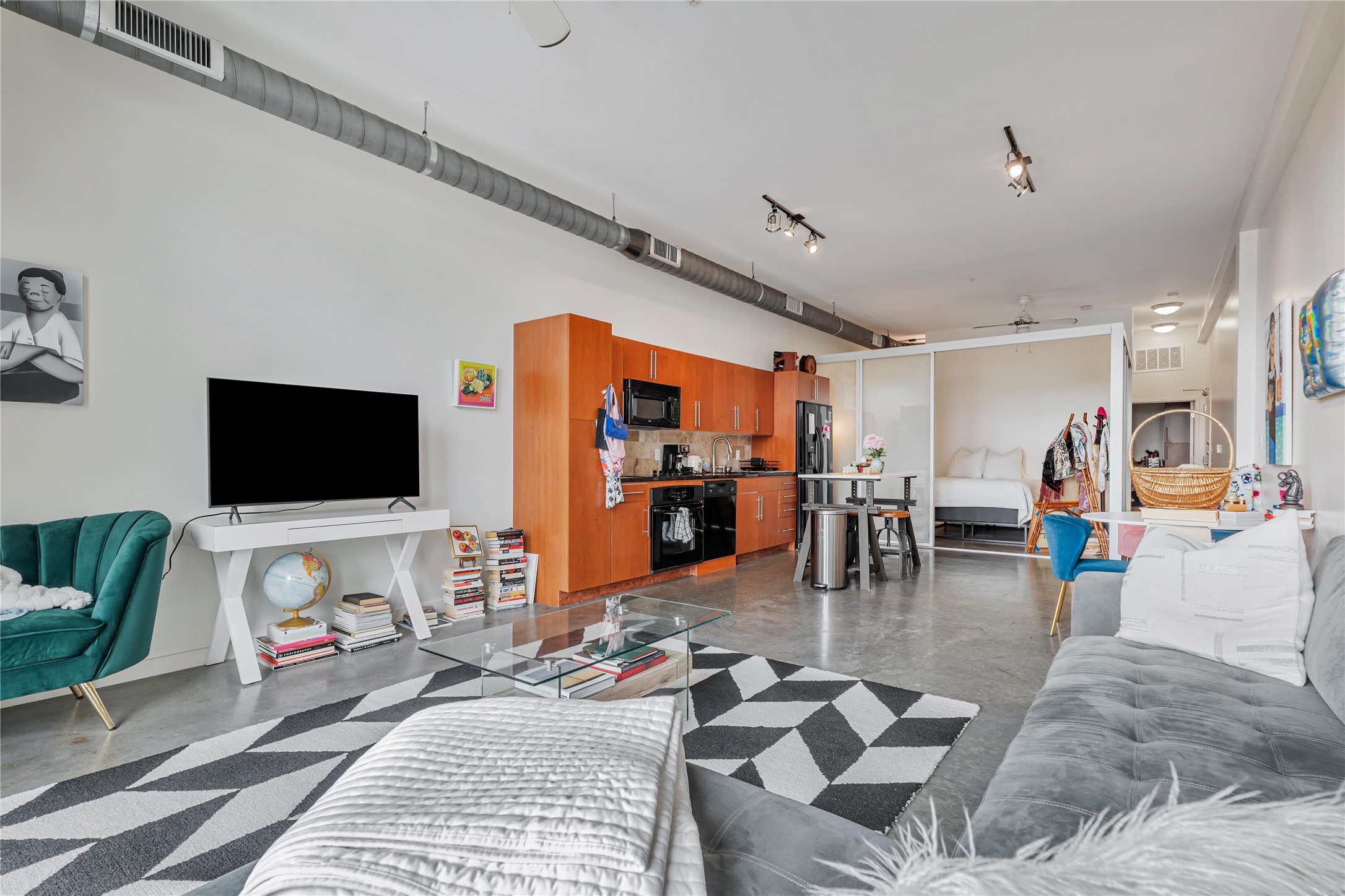 2124 East 6th Street, Unit 305 Austin, TX 78702 - Photo 8 of 35 a living room with furniture and a flat screen tv