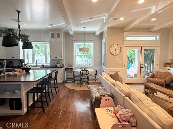 a kitchen with a stove a refrigerator and chairs