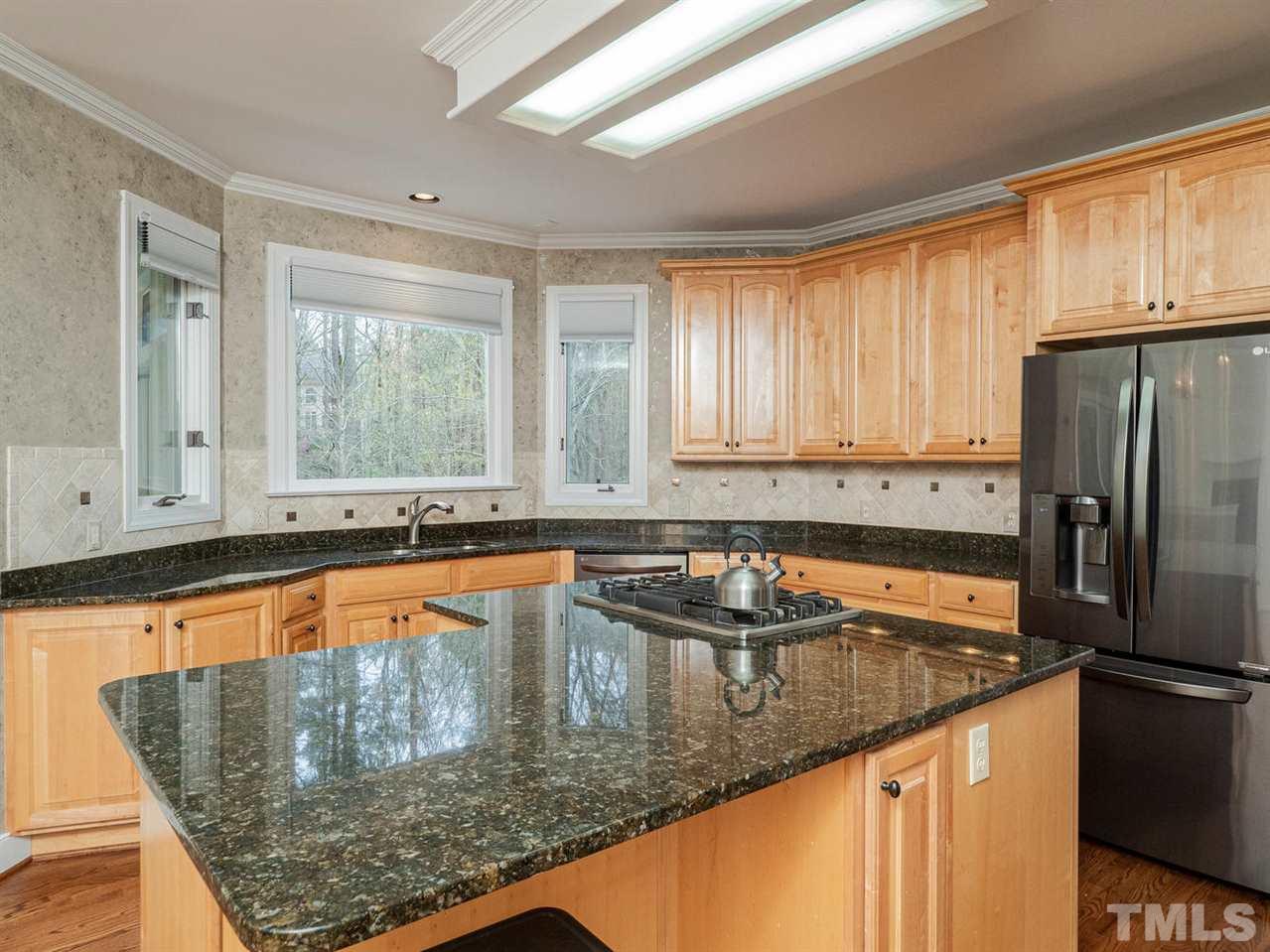 206 Chiselhurst Way Cary, NC 27513 - Photo 13 of 30 a kitchen with stainless steel appliances granite countertop a sink stove and refrigerator
